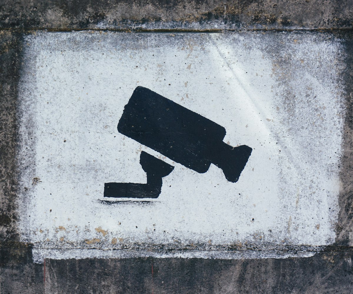 Security camera symbol painted on a wall